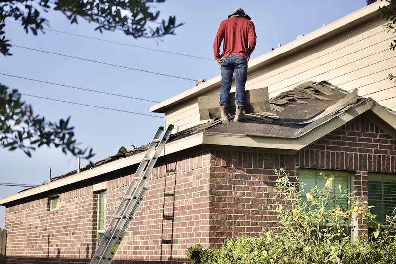 Professional roofer working on a residential roof in Glenloch